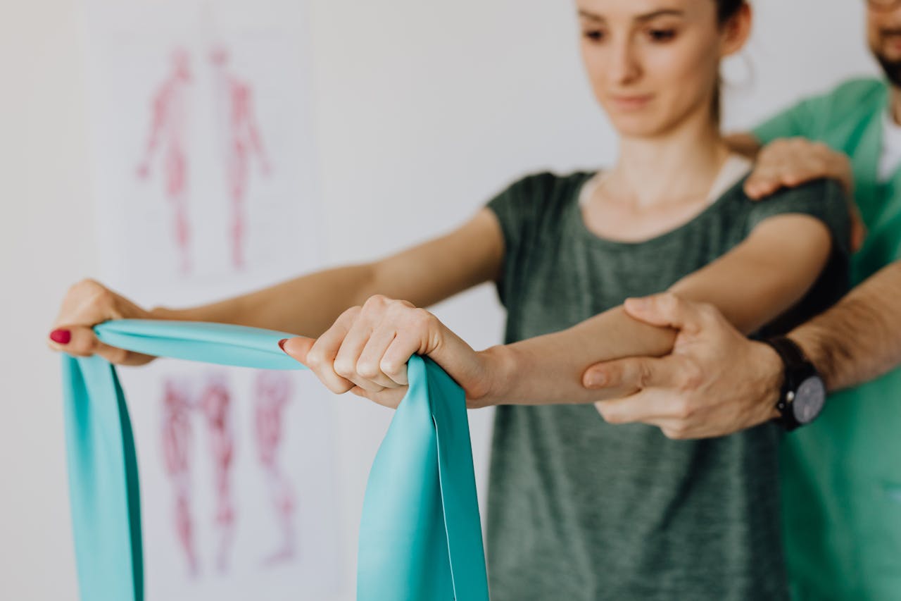 Mastering the First Impression: Your intriguing post title goes here Crop anonymous orthopedist in wristwatch and uniform helping young woman in casual wear reaching arms with elastic tape in doctor office