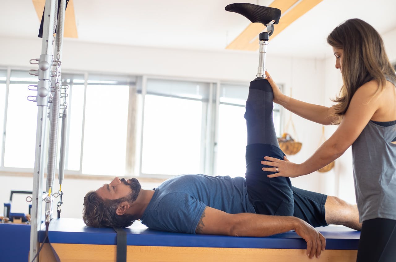 The Art of Drawing Readers In: Your attractive post title goes here Personal trainer assists amputee in rehabilitation exercise indoors.